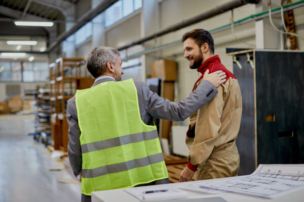 Happy Factory Worker Communicating With Company Manager