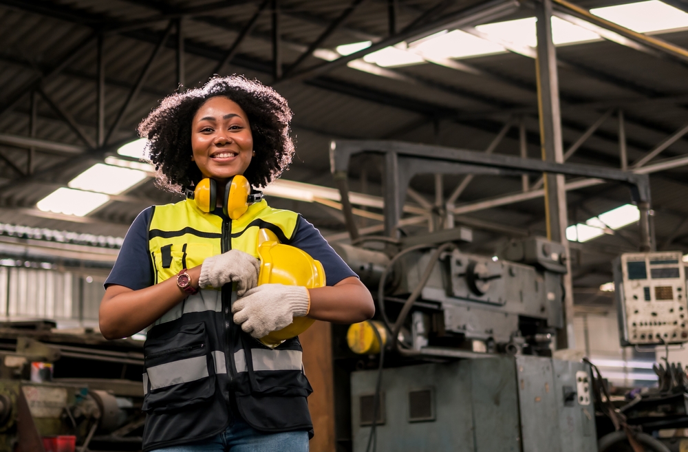 Portrait Of Smiling Engineering With Helmet And Safety Unifrom Standing