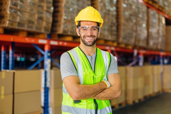 Warehouse Workers Using A Digital Tablet While Recording Inventory