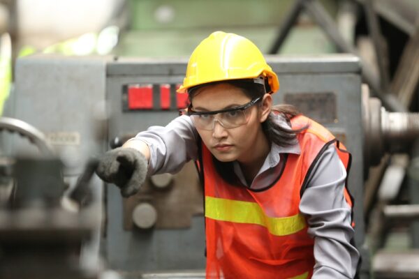 Factory Staff Wearing Safety Goggles Grinding Steel